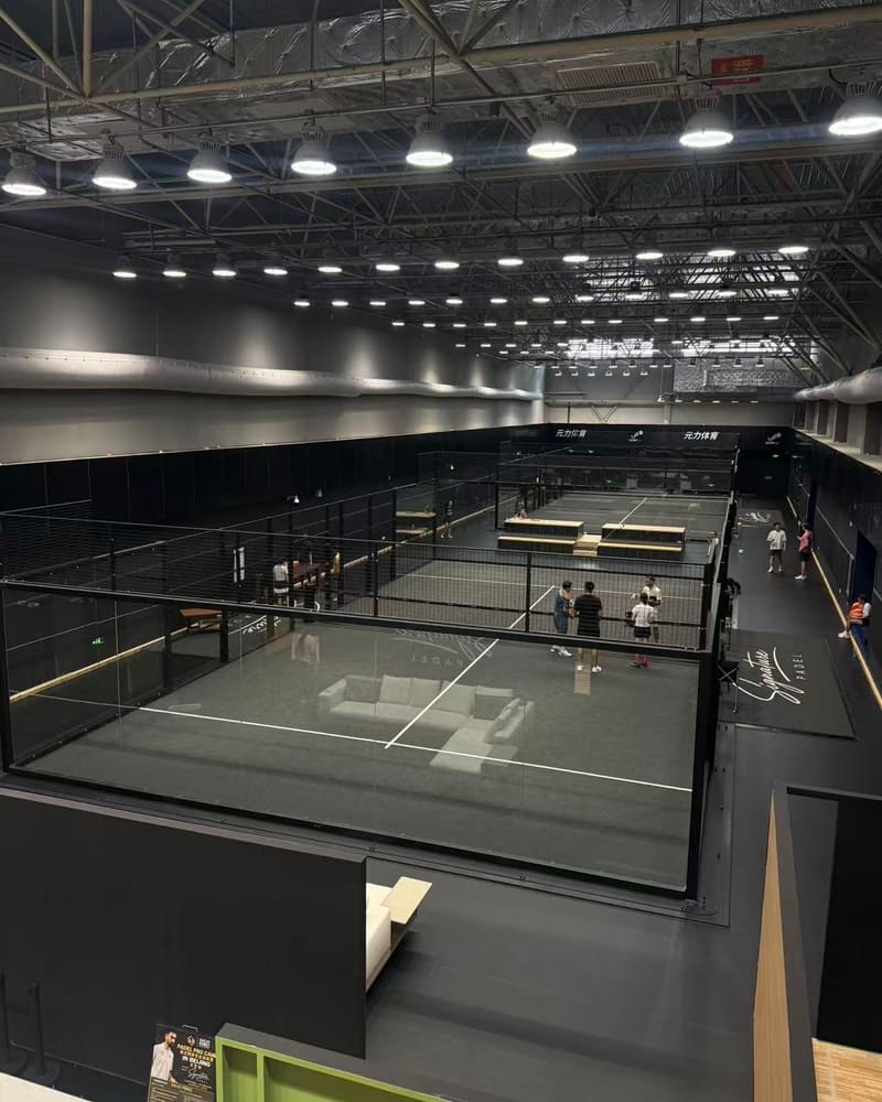 Both glass padel courts seen from above, with players on court